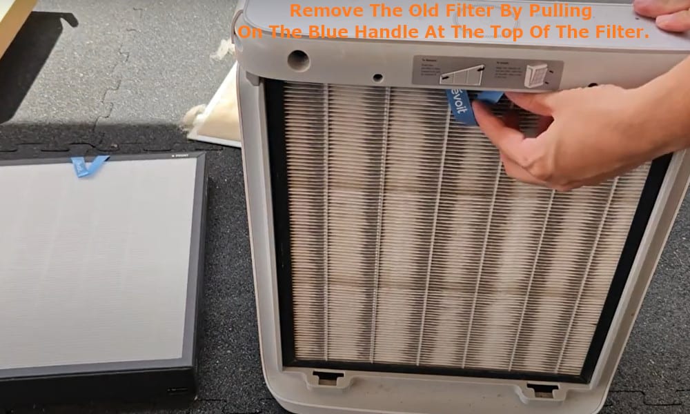 Remove the old filter by pulling on the blue handle at the top of the filter.