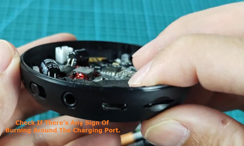 check for is that there are no signs of burning around the charging port